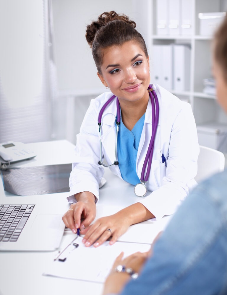 Doctor and patient sitting on the desk at office